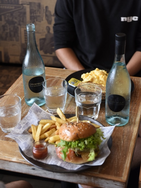 Eating and Drinking with a Bottle of Crystella Sparkling Water