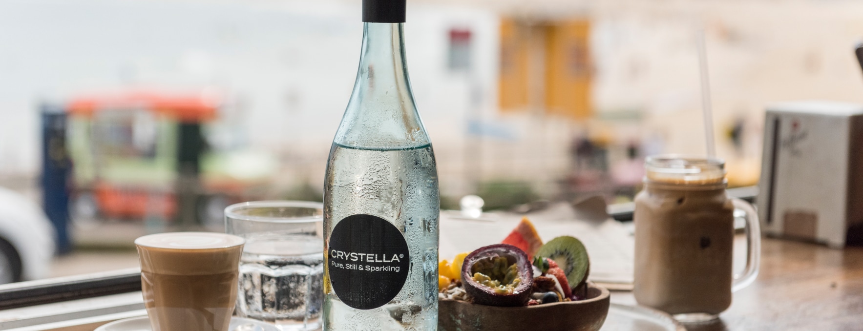 A Bottle of Crystella Pure, Still & Sparkling on Top of the Table